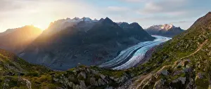 Glacier Prints: View of trekker at Aletsch Glacier during sunset in summer in Riederalp