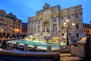 Typically Italian Gallery: View of Trevi Fountain illuminated by street lamps and the lights of dusk, Rome, Lazio