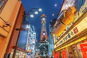 Bustling Prints: View of Tsutenkaku Tower and restaurants neon lights at dusk in the Shinsekai area
