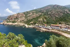 Southern Corsica Prints: Top view of turquoise sea framed by green vegetation and the typical village of Porto