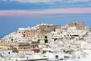 View of typical architecture and white houses of the old medieval town at sunset