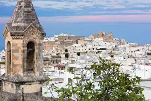 View of typical architecture and white houses of the old medieval town at sunset