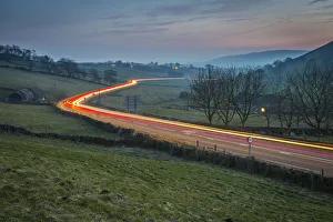 Tail Light Prints: View of vehicle trail lights on A623 at Sparrowpit at dusk, Peak District National Park