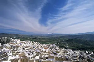 Hill Town Prints: View over village rooftops to distant snow-capped mountains