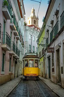 Alfama Prints: View of vintage tram and colourful buildings in the Alfama District on a sunny day