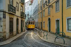 Alfama Prints: View of vintage tram and colourful buildings in the Alfama District on a sunny day