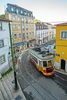 Alfama Prints: View of vintage tram and colourful buildings in the Alfama District on a sunny day