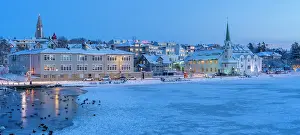 Chill Prints: View of waterfront buildings and city skyline in background in the city centre of Reykjavik at dusk in winter