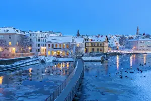 Facades Prints: View of waterfront buildings and city skyline in background in the city centre of Reykjavik at dusk in winter