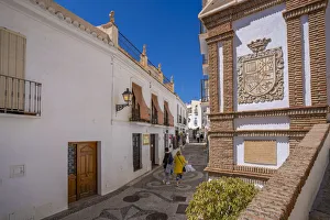 Malaga Province Prints: View of whitewashed houses and shoppers on narrow street