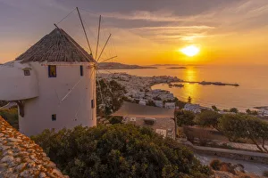 Windmills Prints: View of windmill overlooking town at golden sunset, Mykonos Town, Mykonos