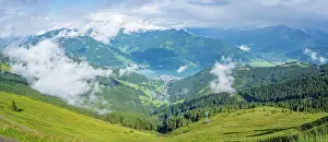 Escape Prints: View of Zell am See from Schmittenhohebahn top station on a sunny day with clouds in the background in Austria