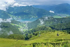 Enjoyment Prints: View of Zell am See from Schmittenhohebahn top station on a sunny day with clouds in the sky and greenery below