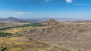 Drone Prints: Views of Alinja castle and surrounding terrain in Nakhchivan region of Azerbaijan under clear sky and distant mountains