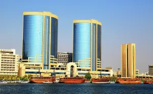 Enjoyment Prints: Views of Dubai Creek showcasing modern buildings and traditional boats in the United Arab Emirates