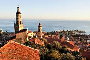 Charming Prints: Views of Menton with rooftops and coastline along the French Riviera in late afternoon light and a clear sky