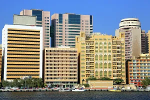 Gulf Prints: Views of modern buildings and traditional architecture along Dubai Creek showcasing urban life in the UAE