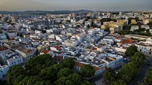 Economy Prints: Views of the old city of Faro in Algarve show buildings and streets in a vibrant urban setting during daylight