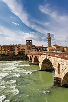 Riverside Prints: Views of Ponte Pietra over River Adige in Verona with buildings along the shore