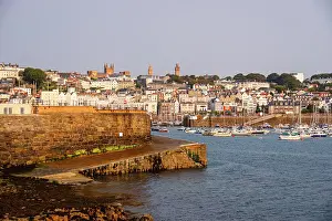 Hour Prints: Views of waterfront and historic buildings during golden hour in Saint Peter Port in Guernsey Channel Islands