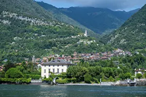 Estate Prints: Villa Balbiano offers a view of the mountains and village by Lake Como in Italy during a sunny day