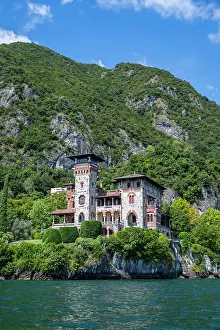 Photographer Prints: Villa Gaeta on the shore of Lake Como surrounded by green hills and blue water under a clear sky