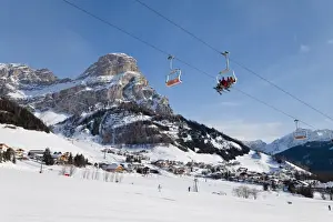 The village of Colfosco in Badia, 1645m, and Sella Massif range of mountains under winter snow