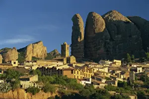 Rock Cliff Prints: Village dwarfed by the pudding-stone cliffs of Mallos de Aguero
