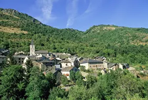 Occitanie Prints: Village of Mijanes sits in the Donezan region under a clear blue sky and surrounded by mountains in Occitanie region