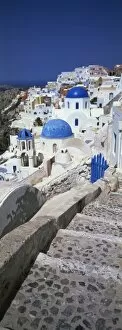 Village of Oia with blue-domed churches and whitewashed buildings