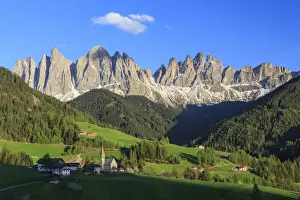 The village of St. Magdalene surrounded by green meadows at the foot of the Odle