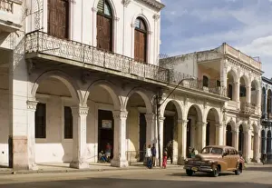 A vintage American car coming along Avenida Reina in central Havana, Cuba