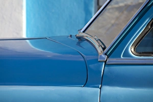 Vintage Car Prints: Detail of vintage blue American car against painted blue wall
