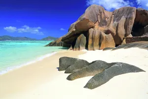 Sunbathing Prints: Visit to Anse Source dArgent beach on La Digue island in Seychelles during bright sunny weather and clear blue skies