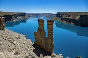 Bright Prints: Visit Band-e-Amir National Park to see the bright blue lake in Afghanistan surrounded by rocky cliffs under a clear sky