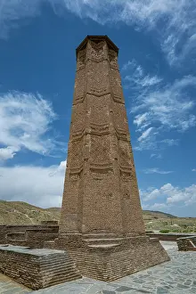 Significance Prints: Visit to Ghazni Minarets showcases ancient architecture in Afghanistan under a bright sky with clouds