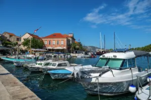 Activities Prints: Visit the harbor in Stari Grad with boats and buildings under a clear sky in Croatia