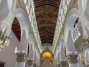 Traditions Prints: Visit to the historic Synagogue of Santa Maria La Blanca showcasing its architectural features in Toledo