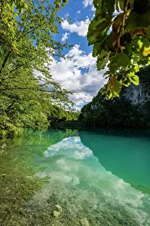 Fresh Prints: Visit Plitvice Lakes National Park in Croatia to see clear waters and lush greenery reflecting in the lake