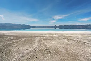 Enjoyment Prints: Visit to Salda lake in Turkey with turquoise water and white sand during sunset with mountains in the background