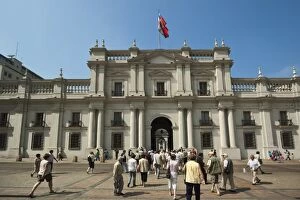 Visitors crossing the Plaza de La Constitucion and the Palacio de La Moneda