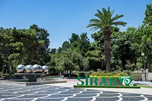 Attractions Prints: Visitors enjoy the greenery and attractions in the central square of Baku