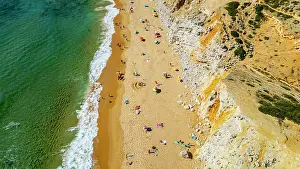 Swimming Prints: Visitors enjoy sunshine and beach activities at Tonel beach in Sagres