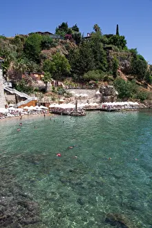 Chairs Prints: Visitors enjoying the sun and water at Mermerli Beach in Antalya Province during a clear day