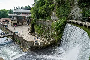 Waterfall Prints: Visitors explore the artificial waterfall and surroundings in New Athon