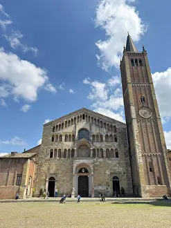 Altar Prints: Visitors explore the exterior of the Cathedral in Piazza Duomo while the sun shines in Parma