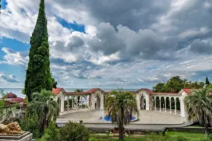 Columns Prints: Visitors explore Gagra Colonnade by the sea in Gagra, Abkhazia under cloudy skies