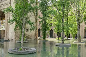 Sculptures Prints: Visitors explore the gardens at Pilotta Palace in Parma with trees and water features present in the landscape