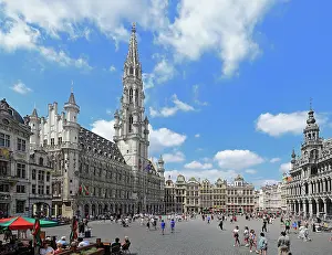 Enjoyment Prints: Visitors explore Grand-Place in Brussels under a bright sky filled with clouds on a sunny day