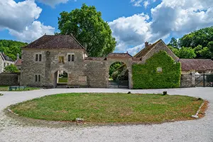 Visitation Prints: Visitors explore the historic Abbey of Fontenay in France with its stone architecture and gardens under a cloudy sky